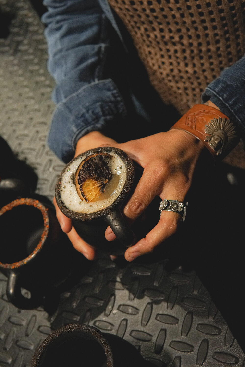 A mezcalita with citrus foam served in a black clay mug at Cebollajo