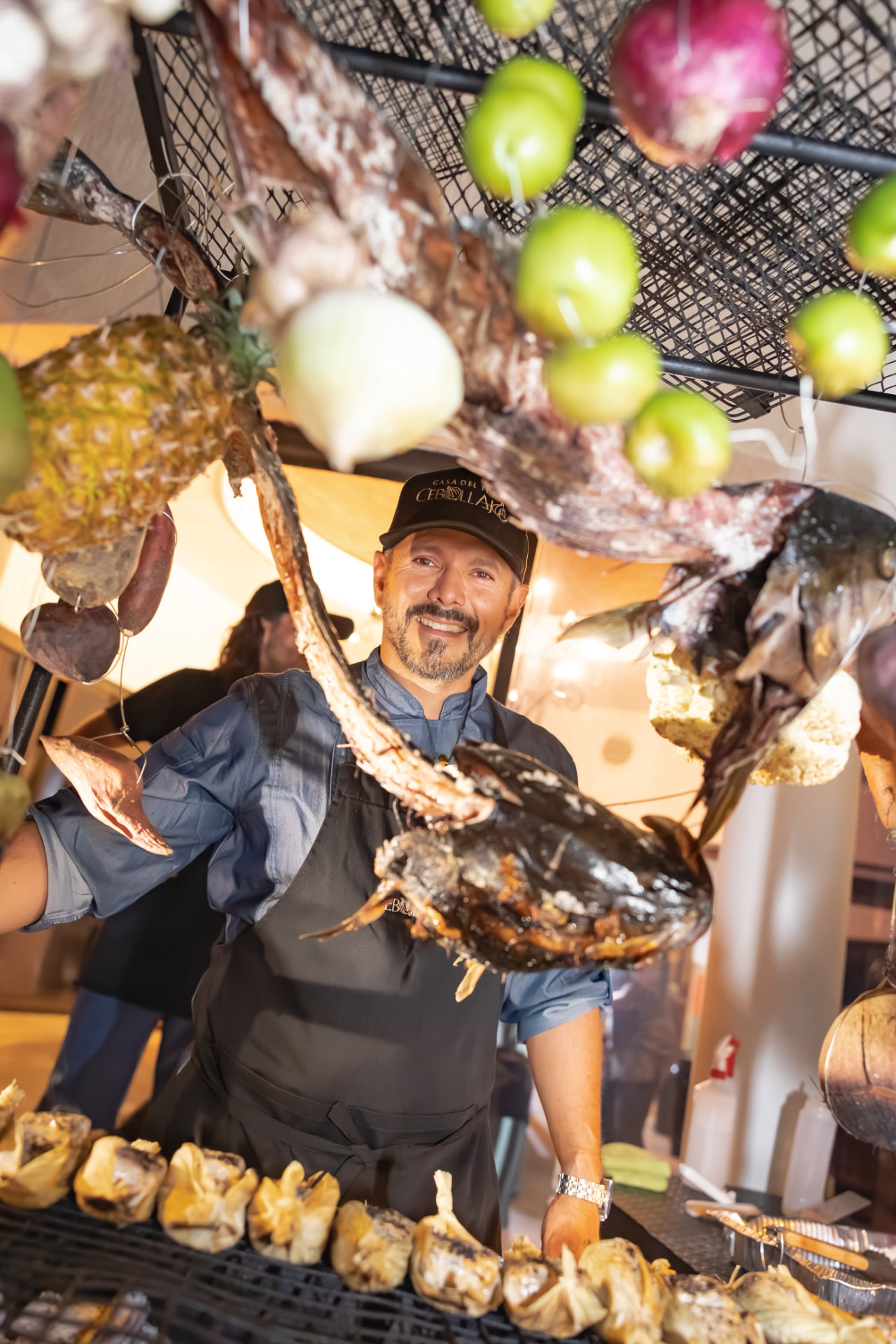 Chef Raymond garnishing a banana-leaf table at a Cebollajo event