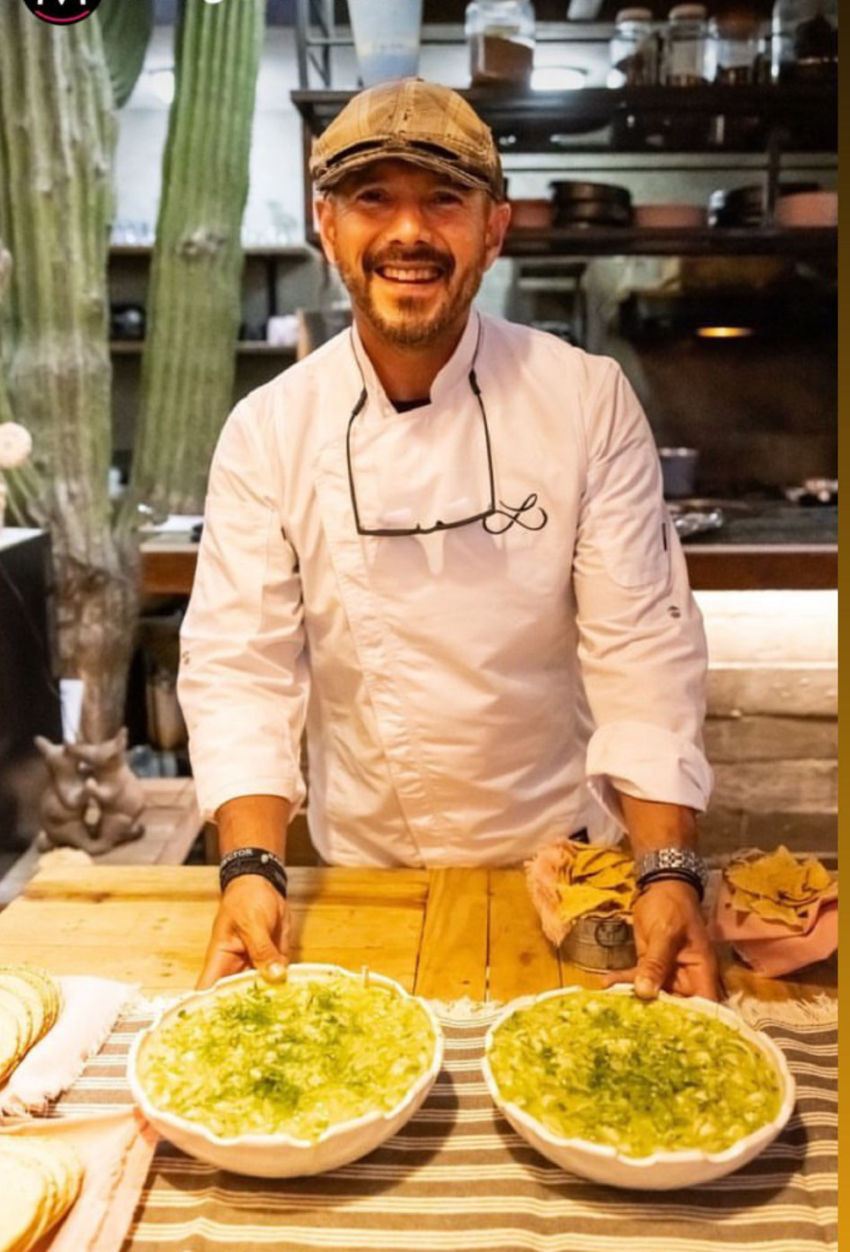 Chef Raymond serving two bowls of green pozole at Cebollajo
